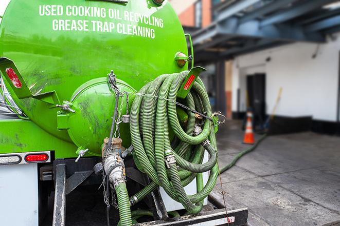 a service truck pumping grease from a restaurant's grease trap in Falls Church, VA